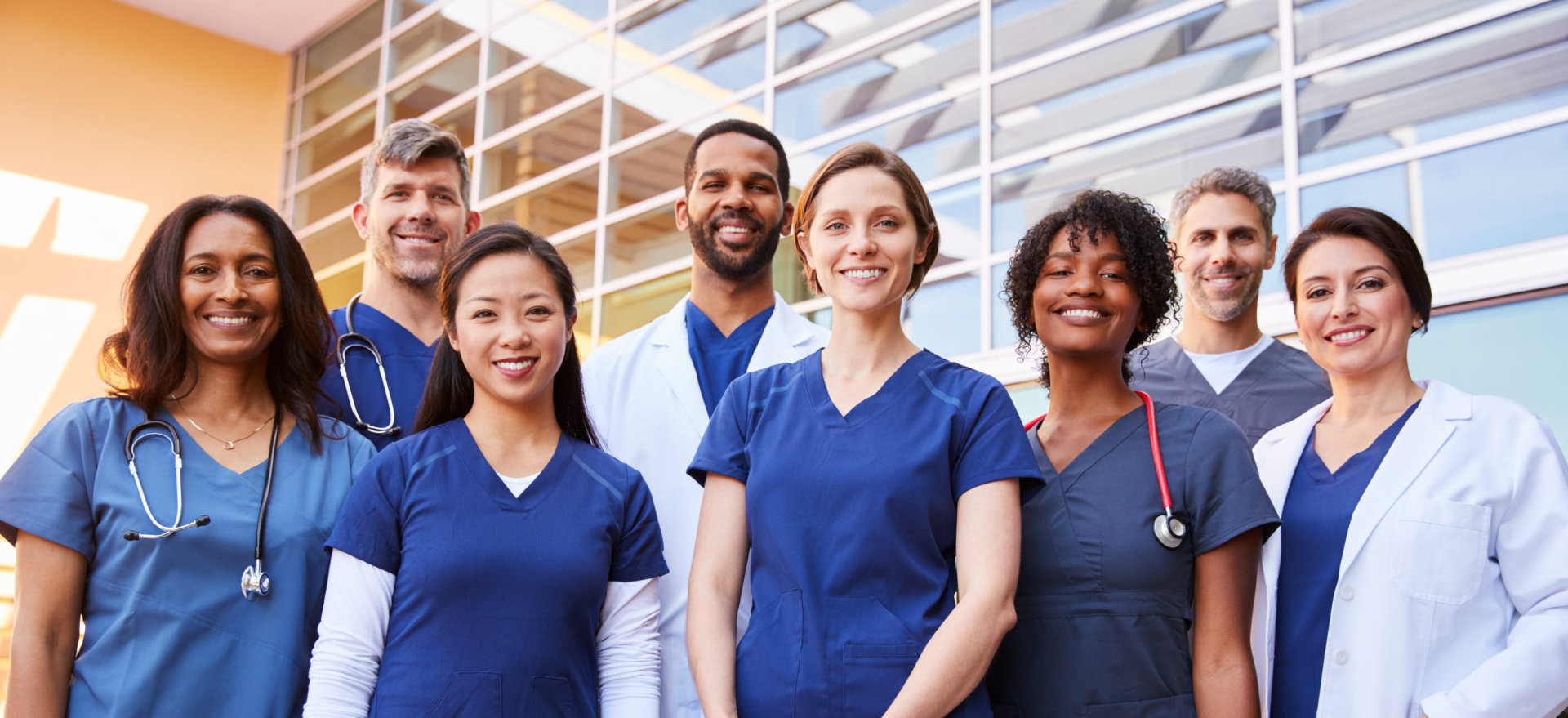 group of medical staff gather outside the building