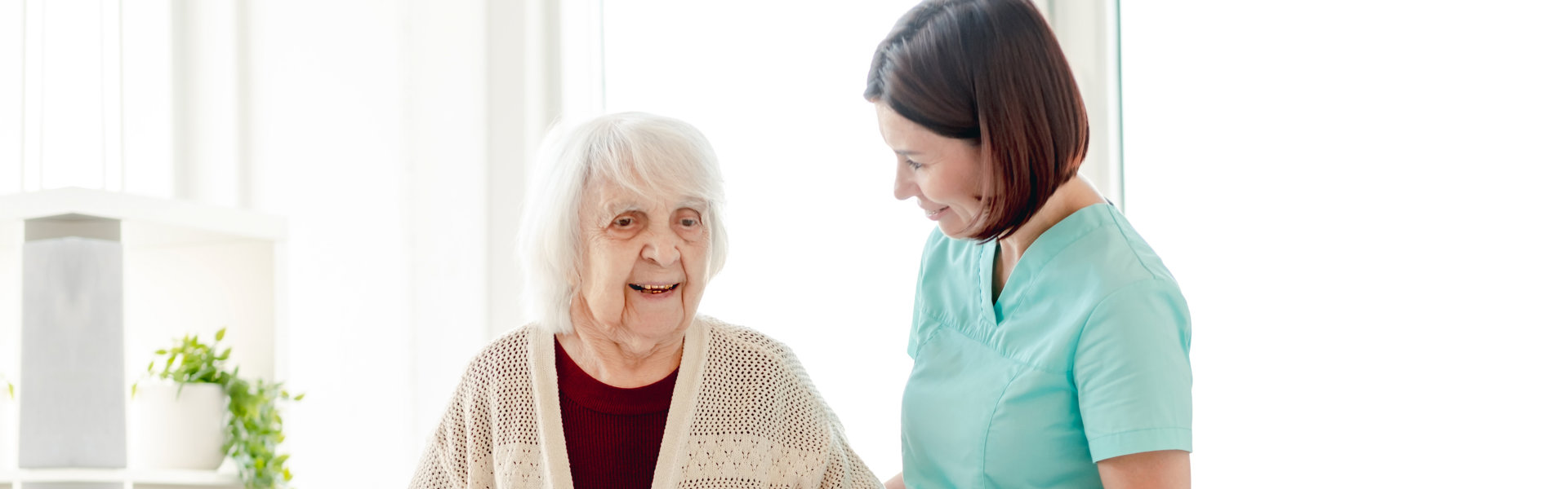 a person smiling at an elderly person