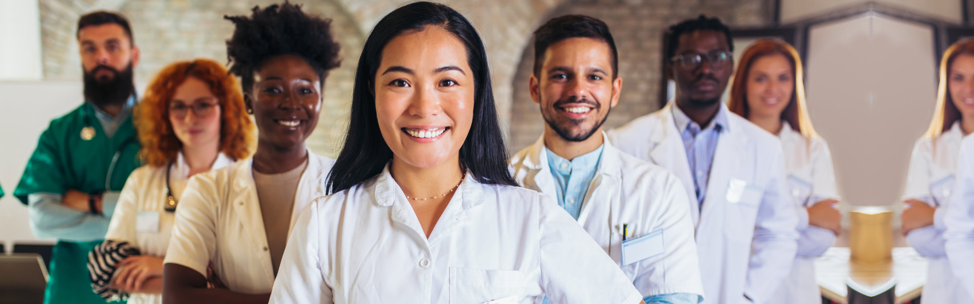 a group of people in white coats smiling